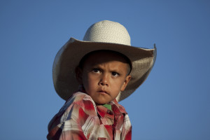 Navajo boy riding in the rodeo